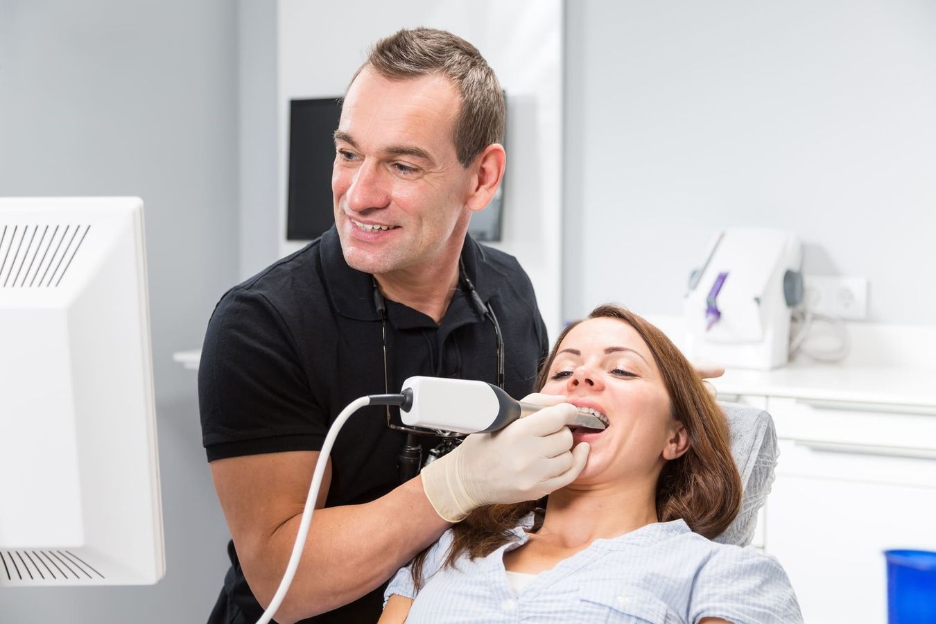 A patient receives an interoral scan from her dentist